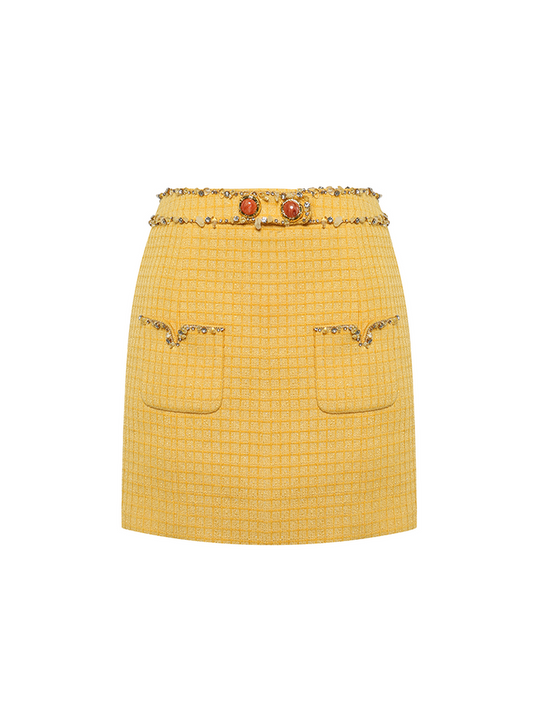 Sophia embellished tweed mini skirt in vibrant yellow with a high-waisted fit, crystal embellishments, gemstone belt, and front pocket details, crafted from 100% polyester.