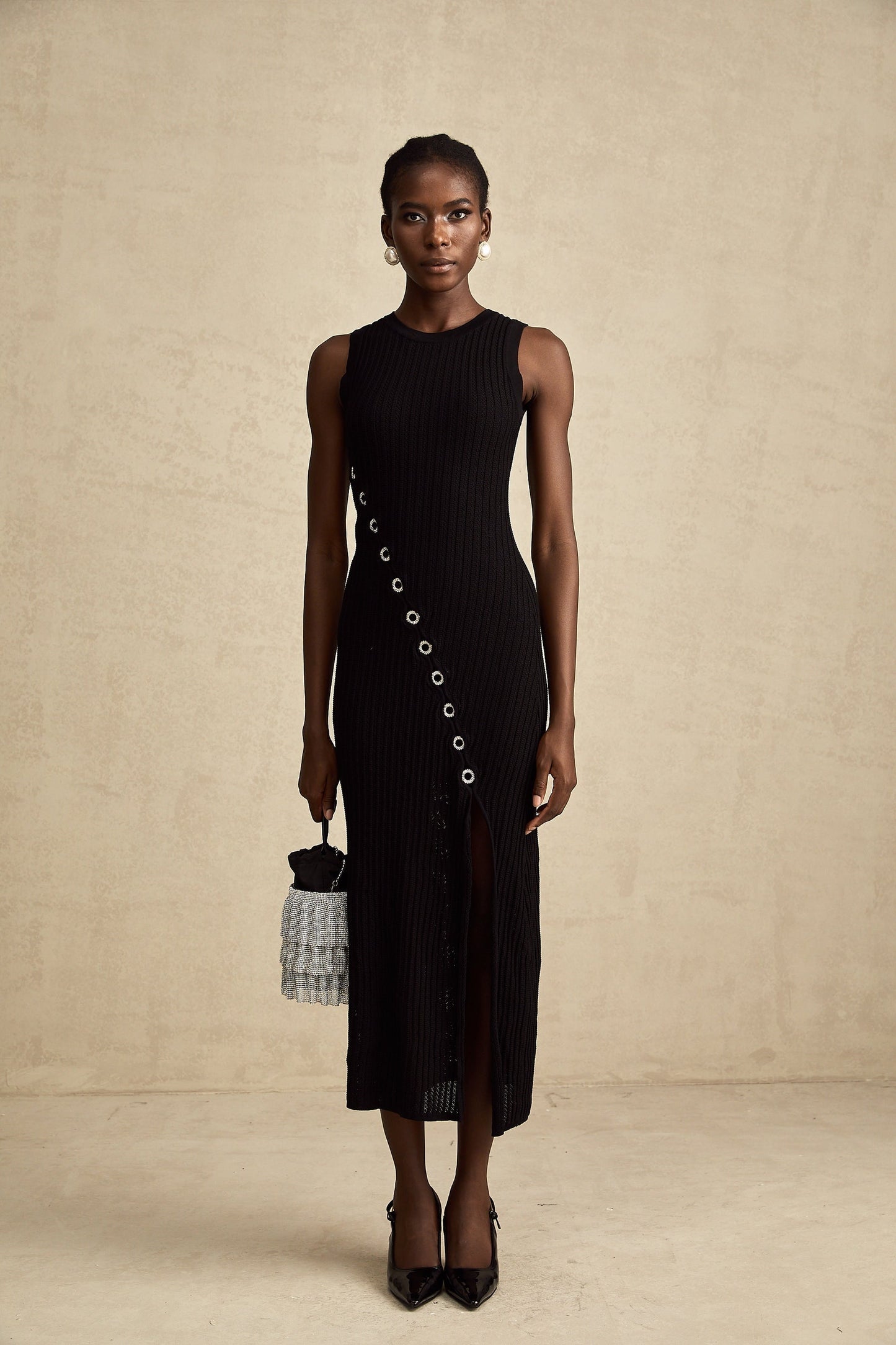 A black knitted midi dress with hoop embellishments