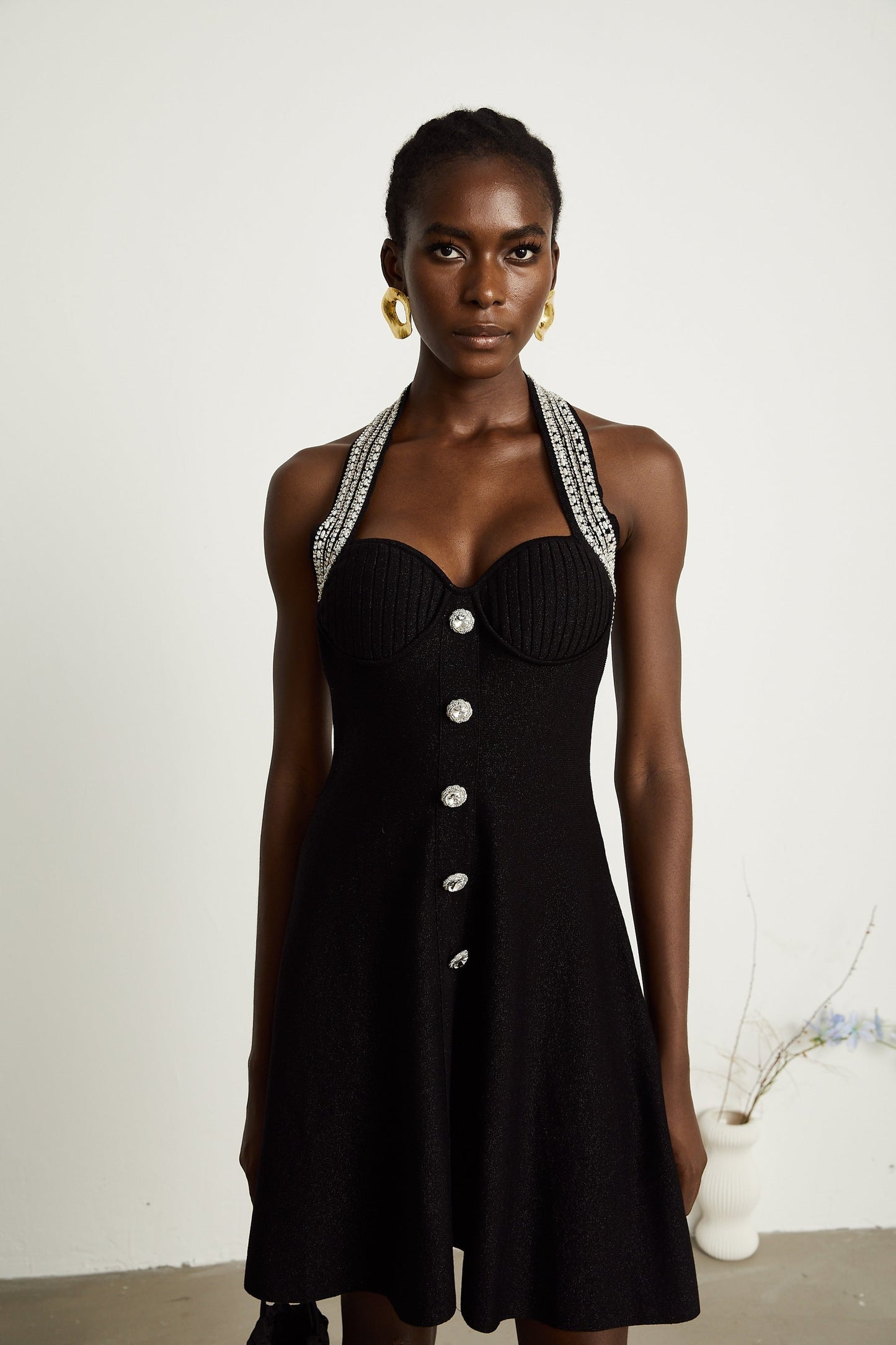 A black knitted mini dress with embellishments