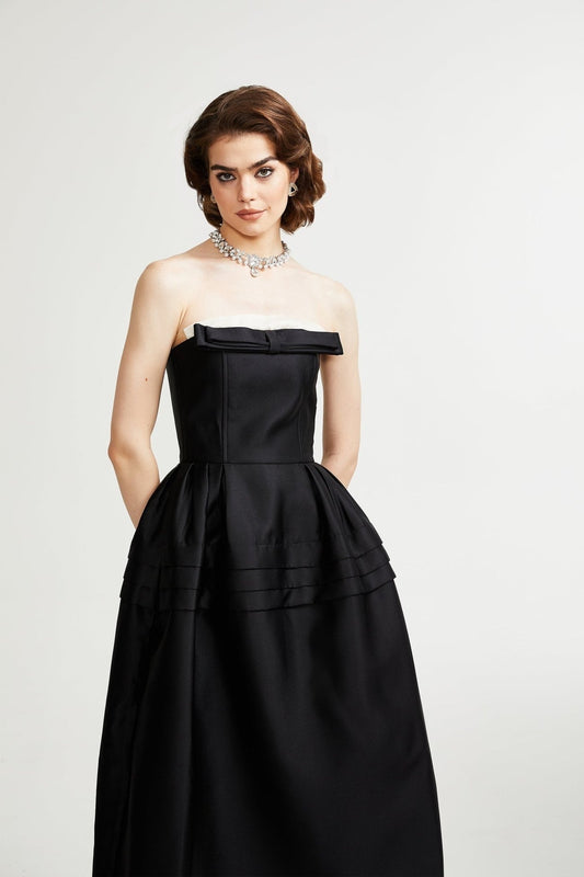 A black midi dress with a prominent bowknot detail