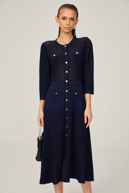 A blue knitted long sleeve midi dress with a ribbed texture