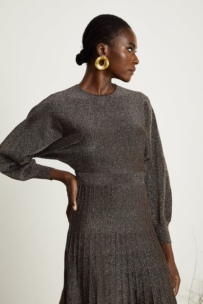 A brown ribbed midi dress with metallic threading and a fitted silhouette