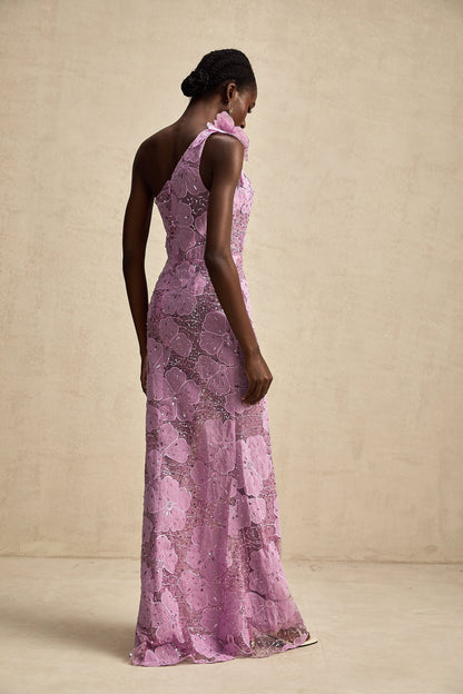 A long purple dress with floral applique details and a flowing maxi silhouette