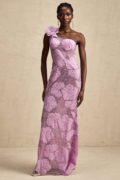 A long purple dress with floral appliques scattered across the fabric featuring a flowing maxi silhouette