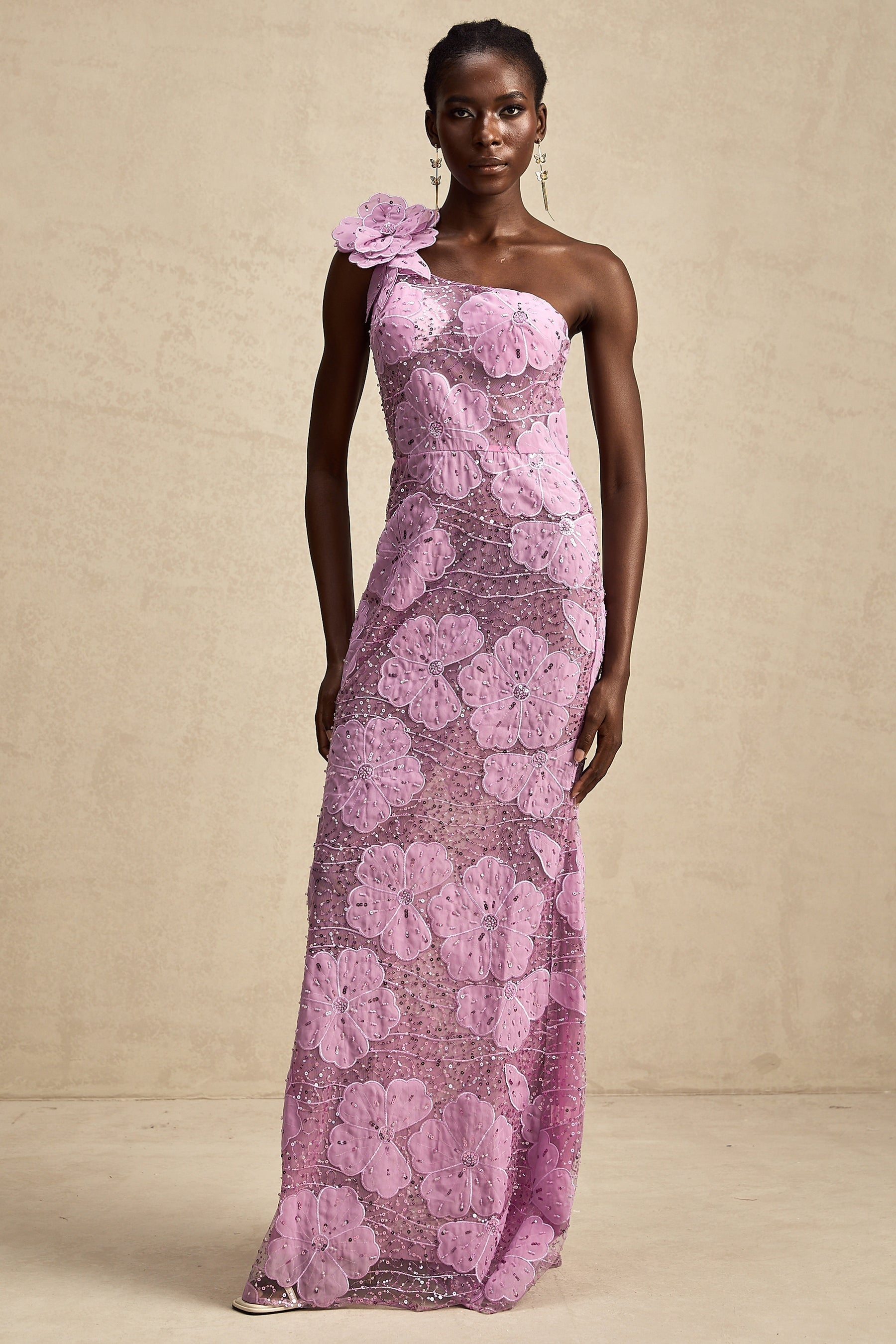 A long purple maxi dress with floral applique details