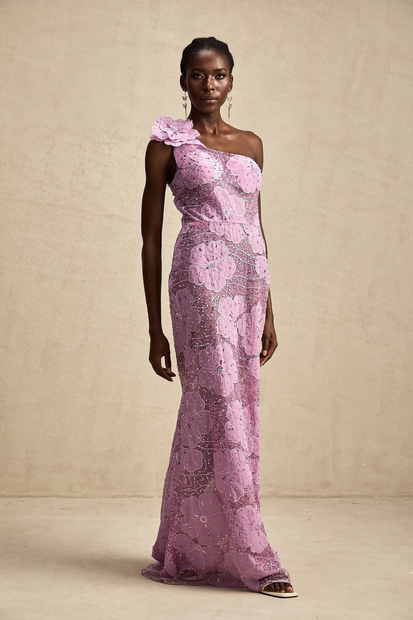 A long purple maxi dress with floral applique details