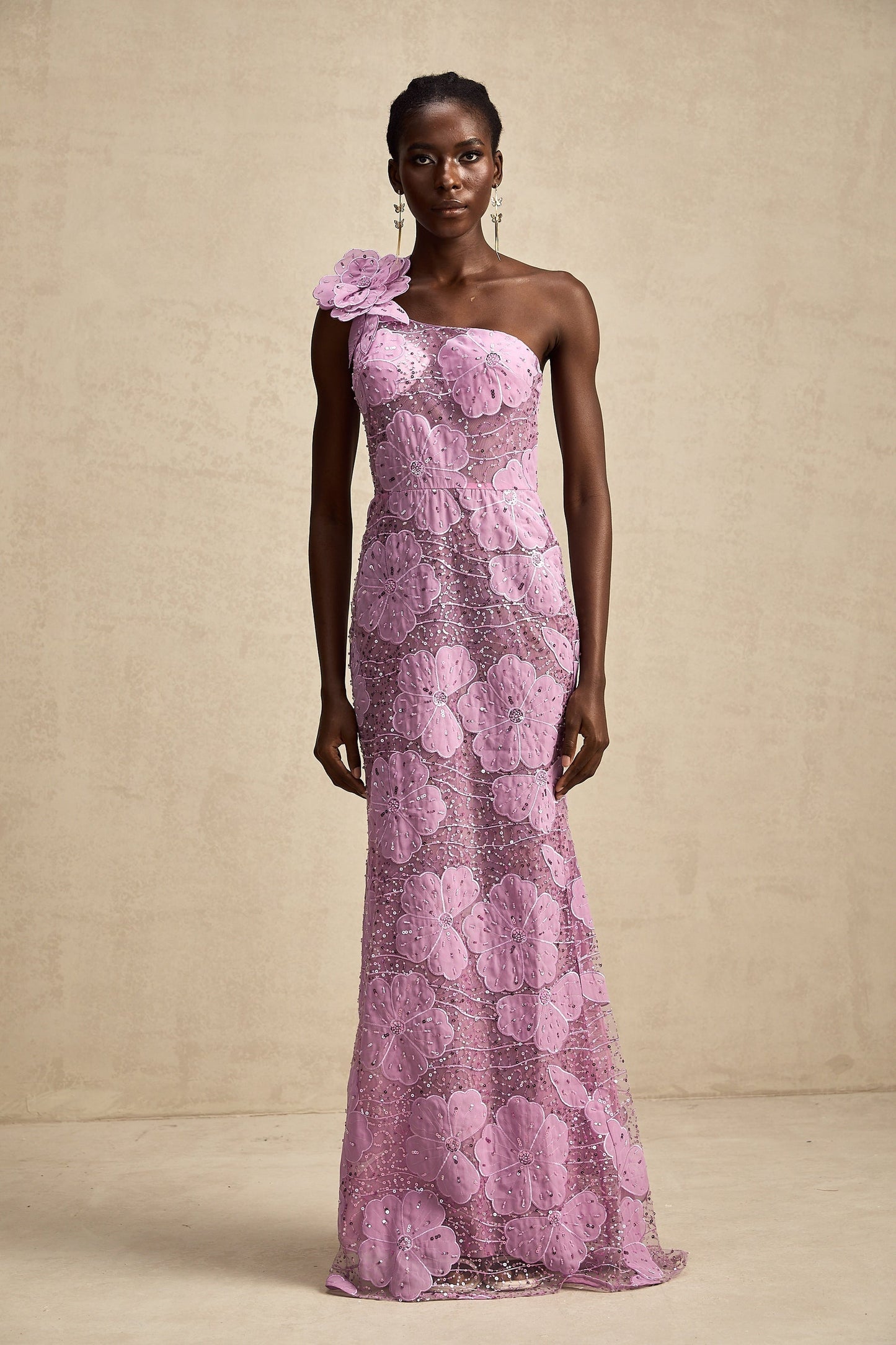 A long purple maxi dress with floral applique details