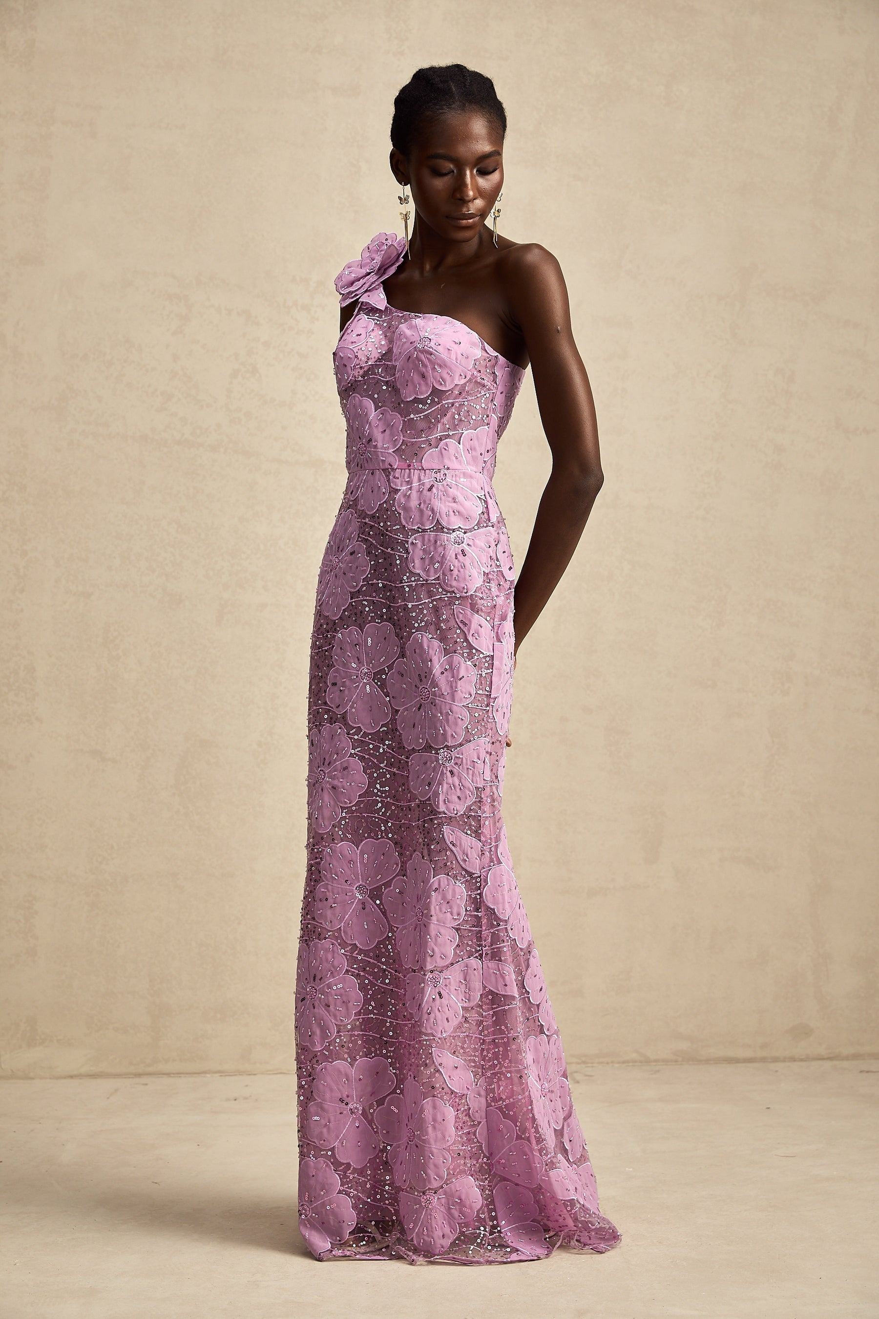 A long purple maxi dress with floral applique details