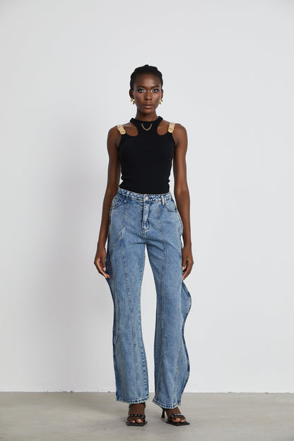 A pair of asymmetric wide leg jeans with one leg wider than the other named Brigitte