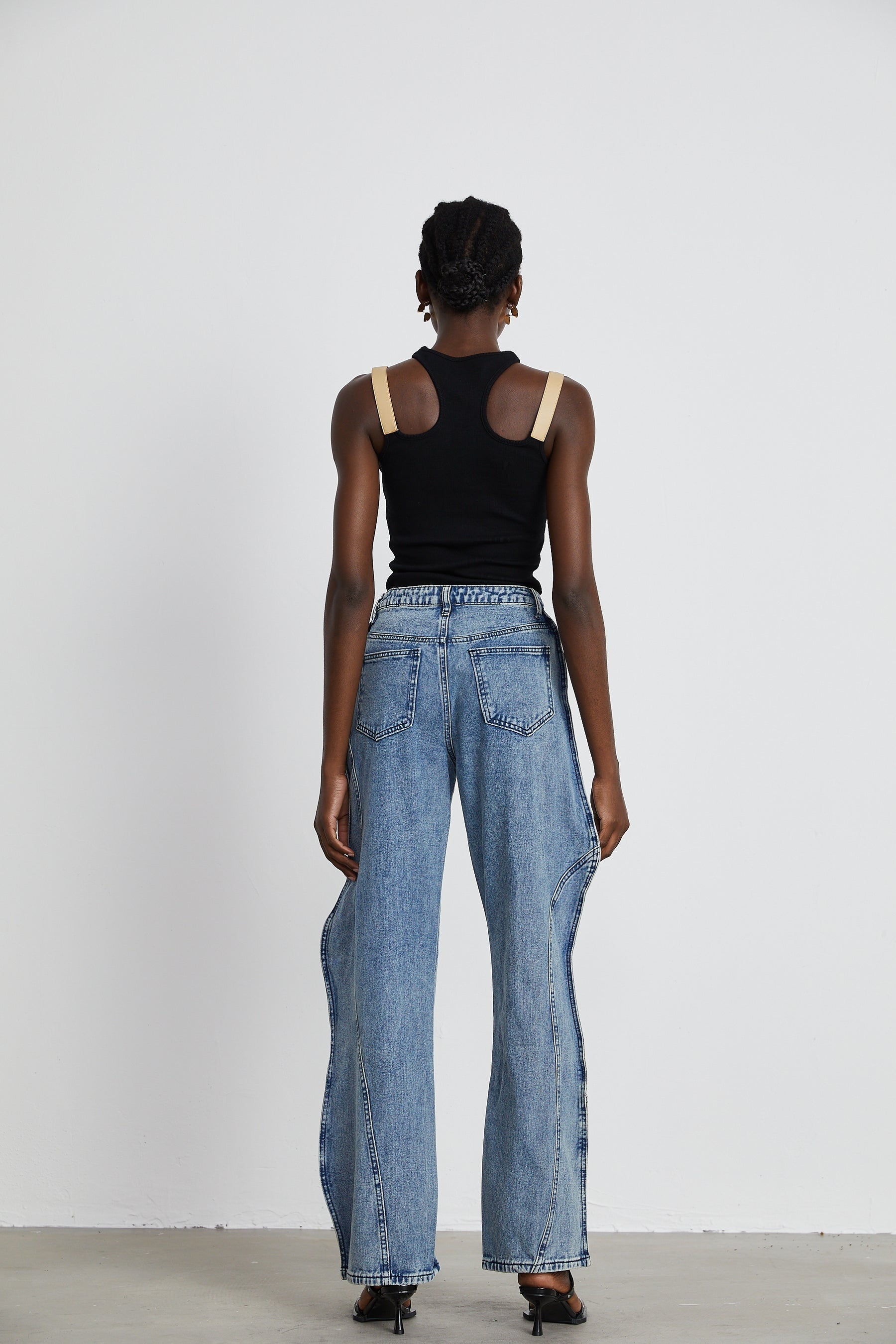 A pair of asymmetric wideleg jeans named Brigitte featuring an uneven hemline and relaxed fit