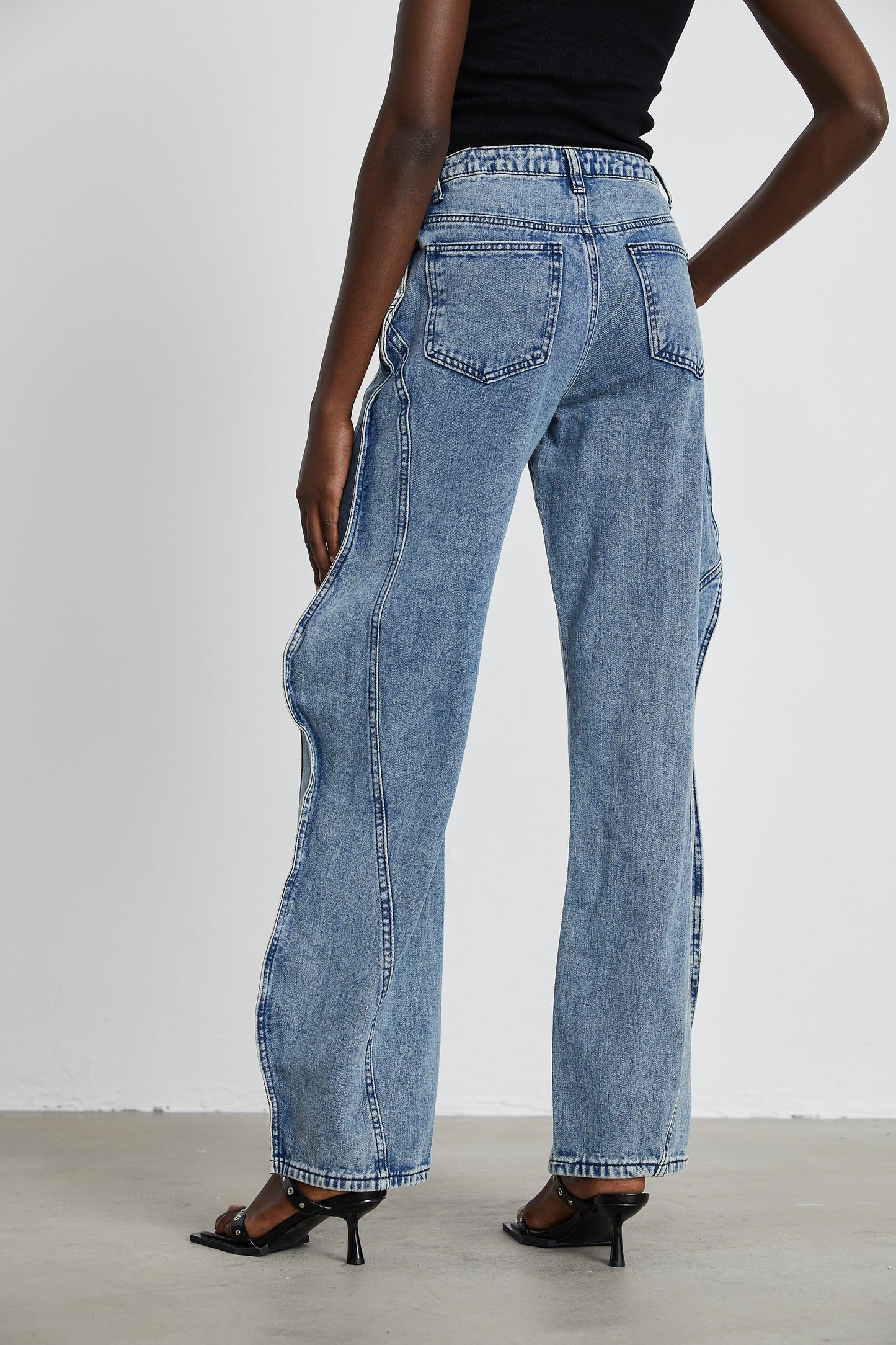 A pair of asymmetric wideleg jeans named Brigitte featuring an uneven hemline and relaxed fit