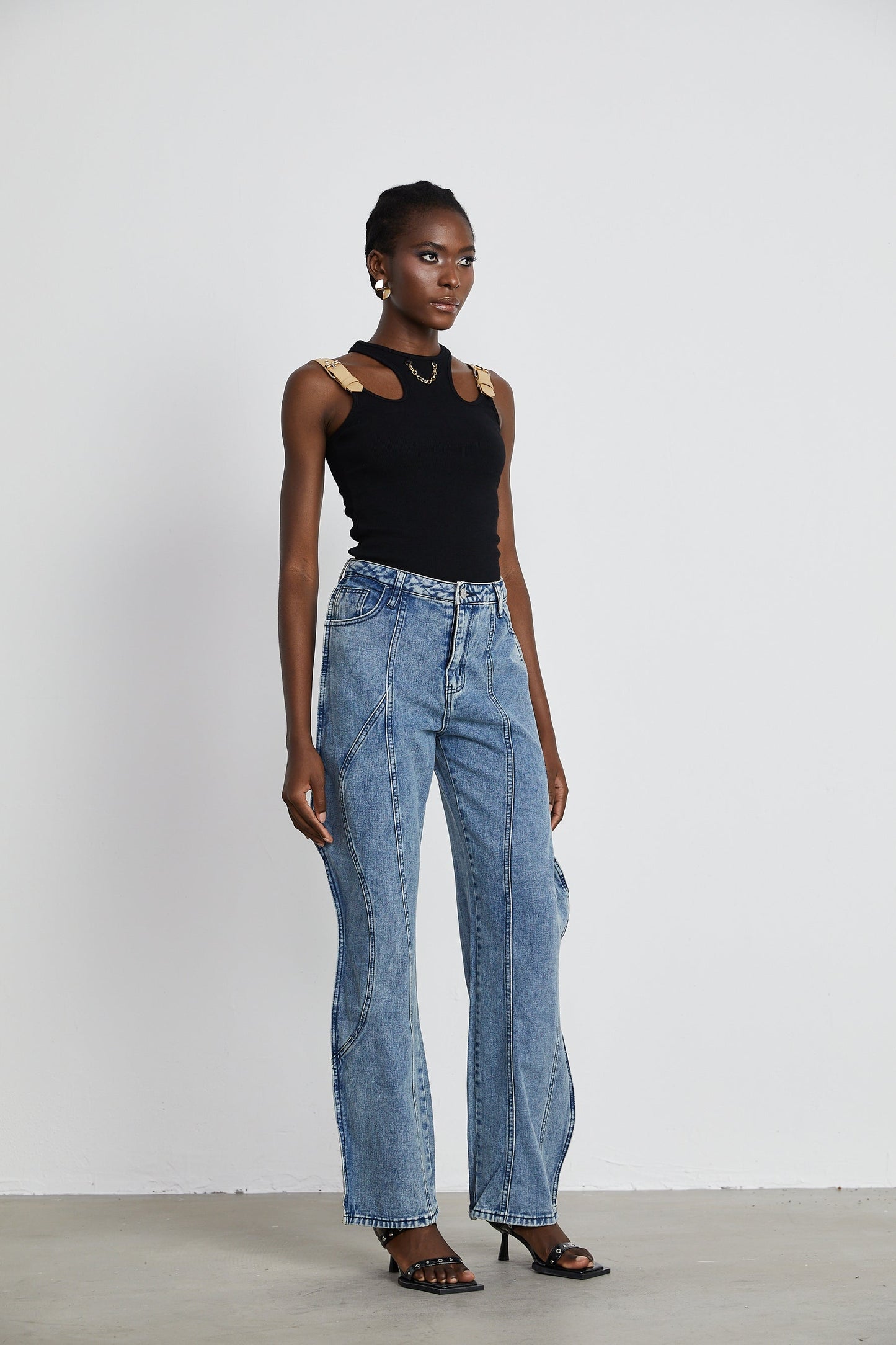 A pair of asymmetric wideleg jeans with one leg longer than the other creating a unique silhouette named Brigitte