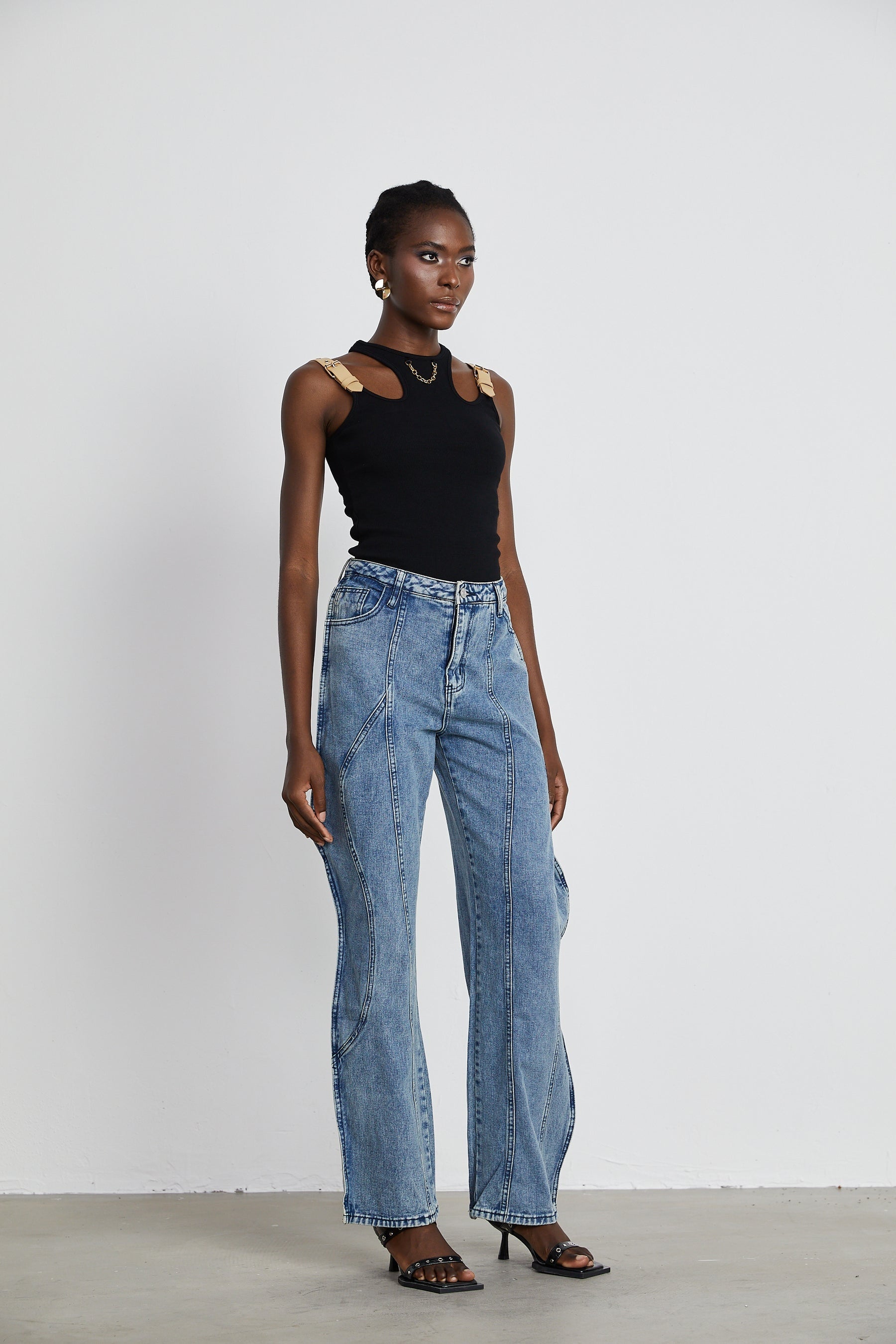 A pair of asymmetric wideleg jeans with one leg longer than the other creating a unique silhouette named Brigitte