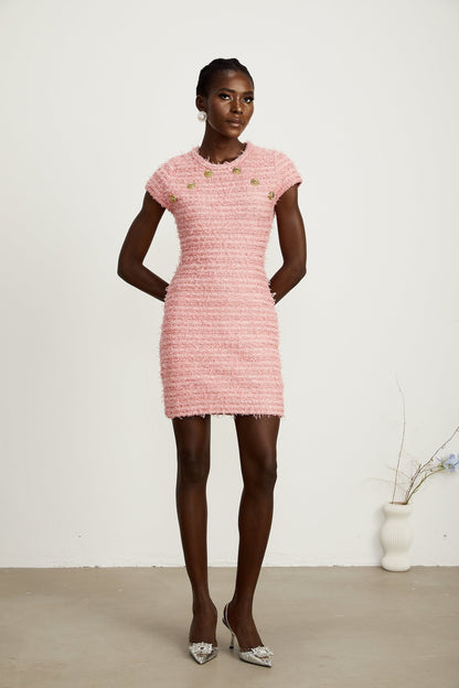 A pink knitted mini dress with fringe detailing