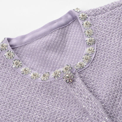 Lavender mini dress with circular neckline short sleeves tweed fabric sequin embellishments faux pearl details four front pockets front button closure thighlength 80% Polyester 20% Cotton