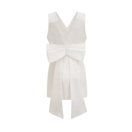 A short white mini dress with a prominent bow detail likely featuring a feminine and playful design in the style of Loubella