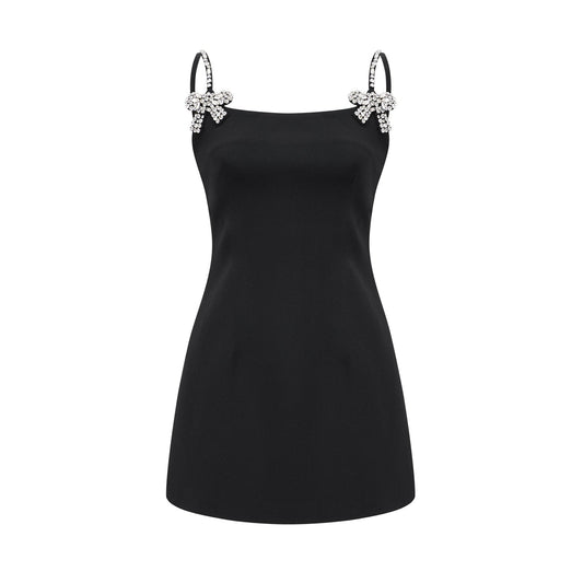 Sleeveless dress with thin spaghetti straps deep Vneckline square neck crystal bow embellishment rear zipper and mini length made of 68% Cotton 32% Polyester