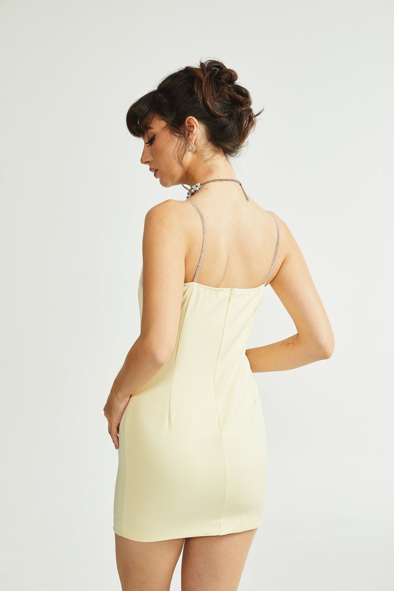 A short yellow dress with a fitted bodice and flared skirt suitable for casual summer wear