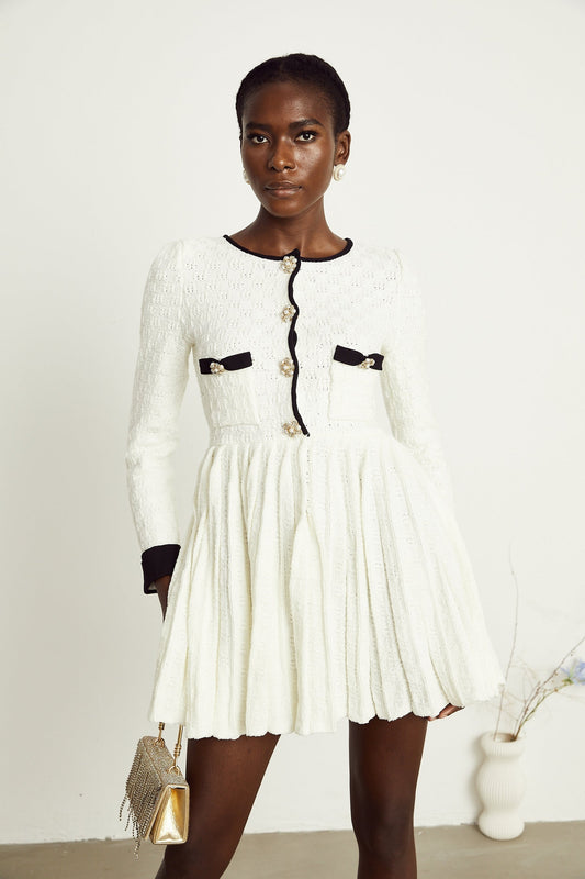 A white knitted mini dress with pleated details