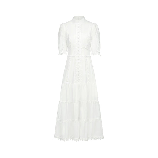 White midi dress with crew neck short puff sleeves floral embroidery lace trim and semisheer construction Rear button and zip fastening Made of 80% Cotton 20% Viscose