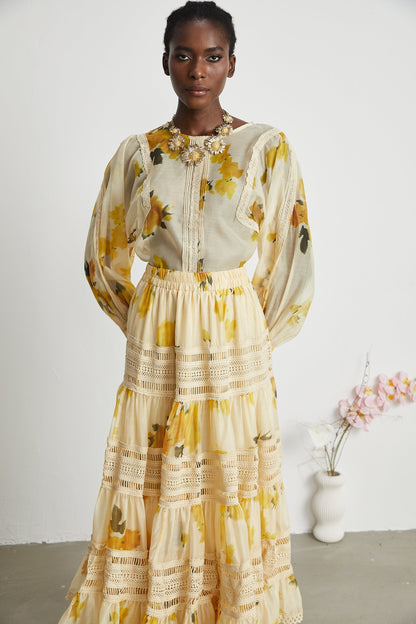 African American woman wearing yellow floral patterned lace dress