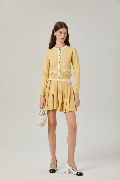 a matching wool cardigan and skirt set in a soft color