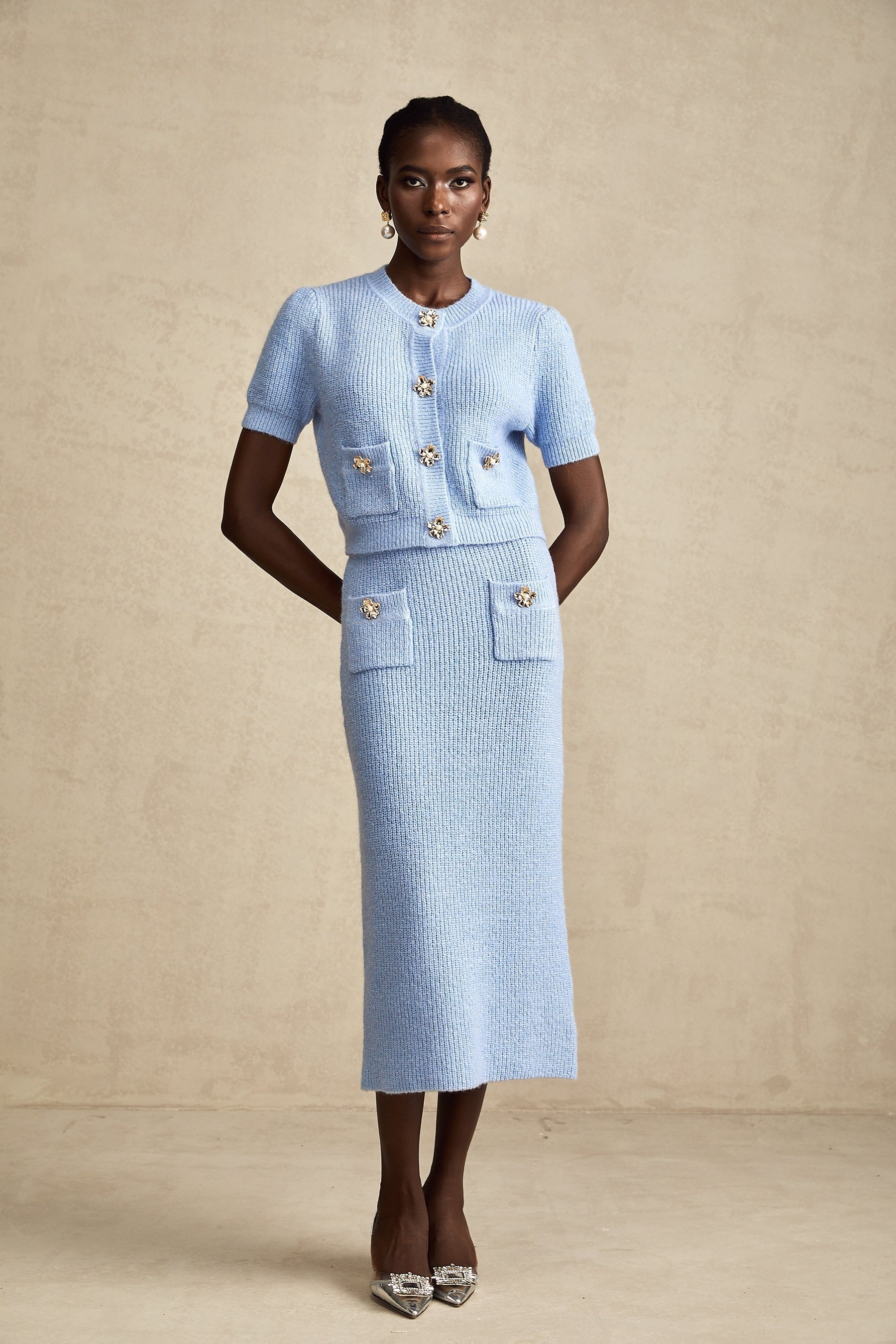 a matching blue knit blouse and skirt set