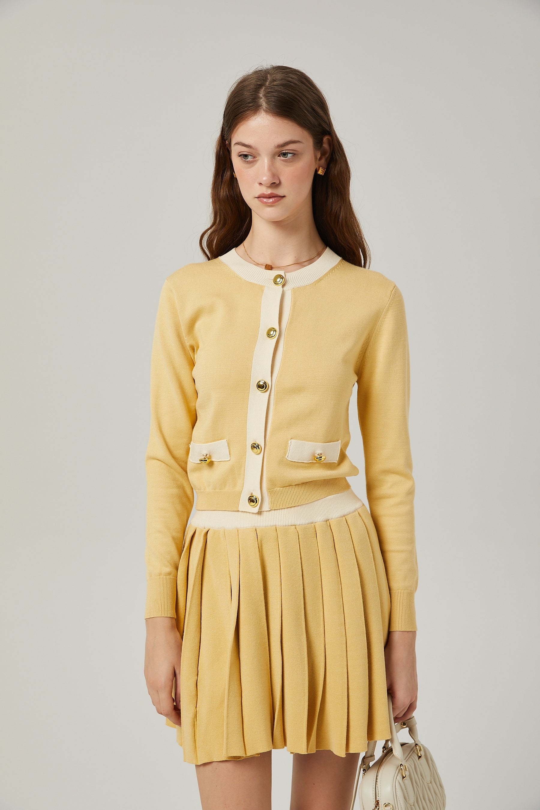 a matching wool cardigan and skirt set in a soft color