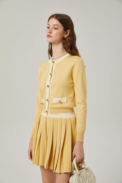 a matching wool cardigan and skirt set in a soft color