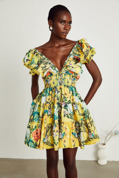 A yellow mini dress with a floral print pattern and ruffled details