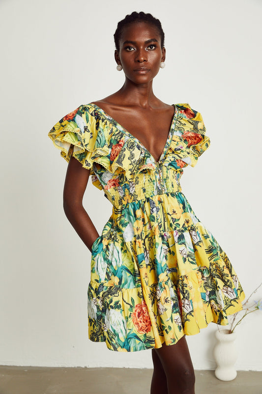 A yellow mini dress with a floral print pattern and ruffled details