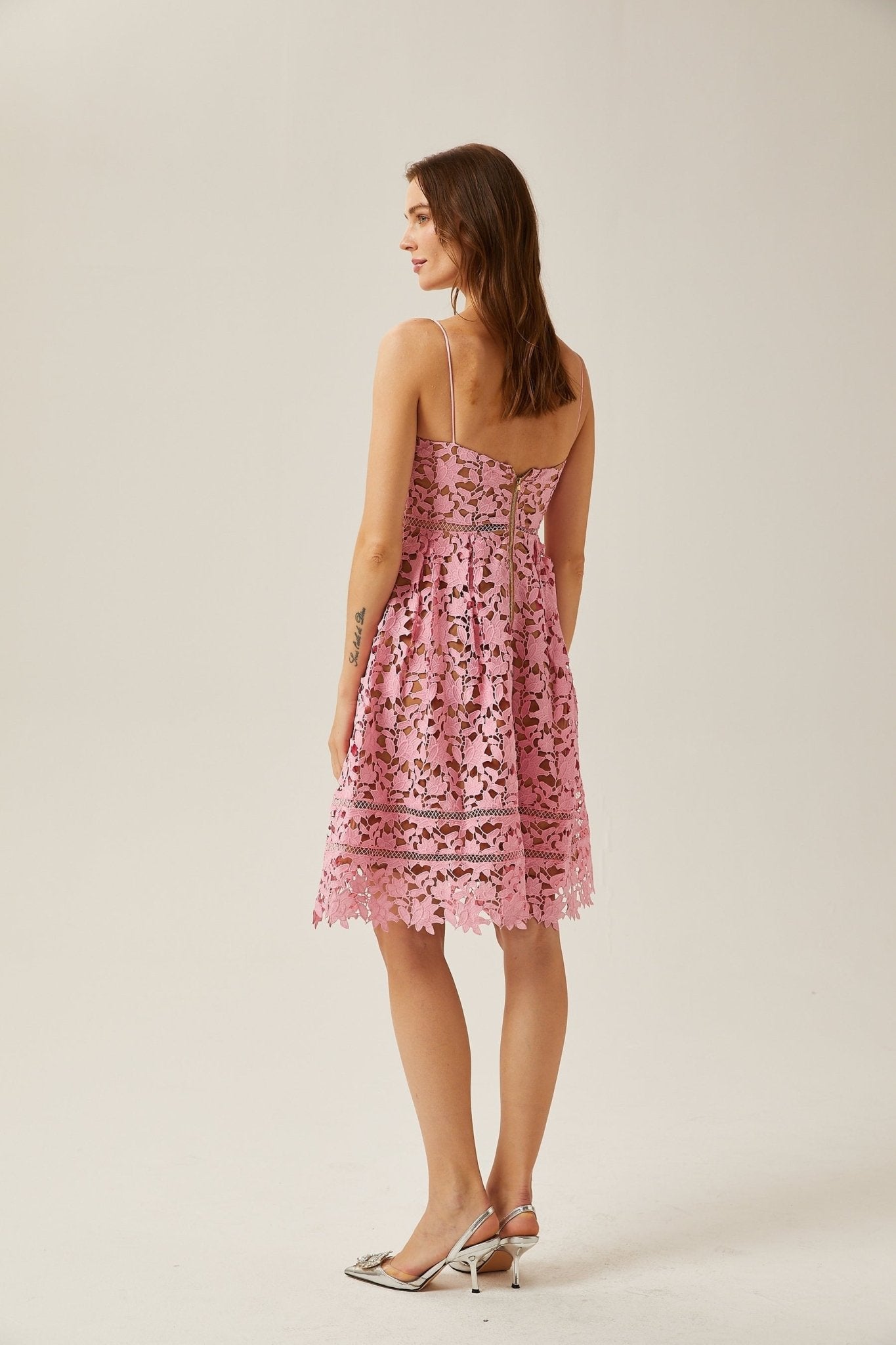 A chic lace midi dress with elegant cut-out accents