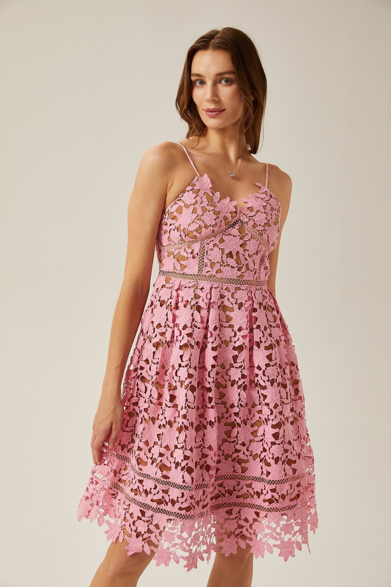 A polished midi dress designed with intricate lace and stylish cut-outs