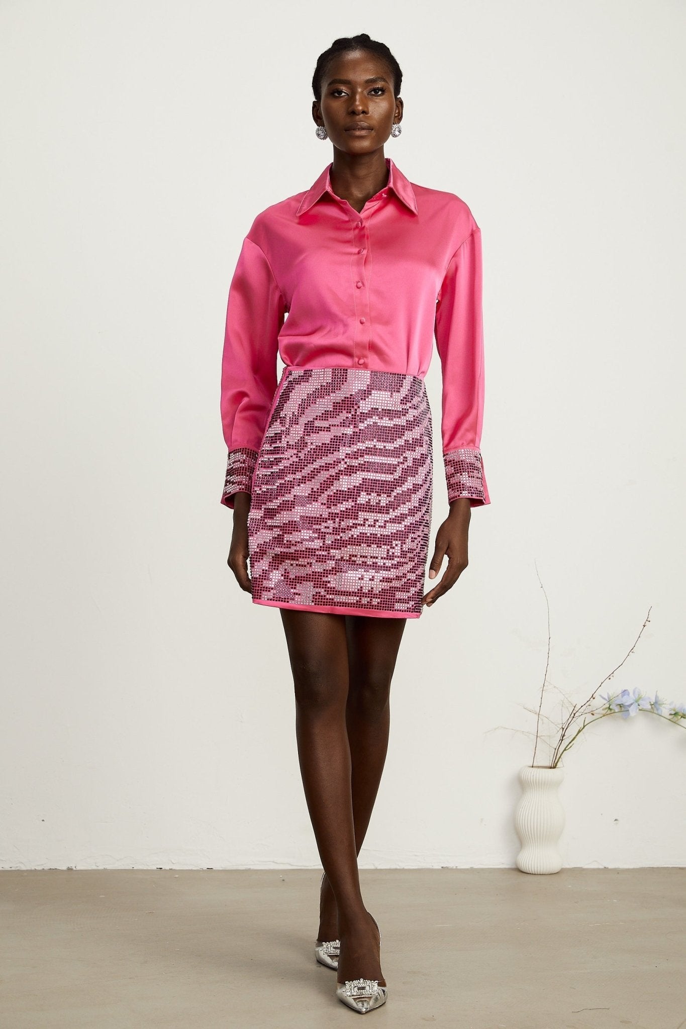 A modern beaded shirt and skirt matching set crafted from satin fabric