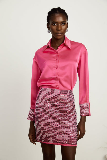 A timeless shirt and skirt matching set with a satin finish and beaded accents