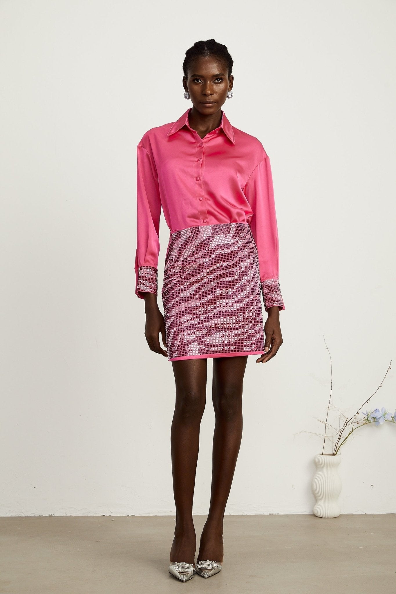 A chic matching set featuring a satin shirt and skirt adorned with beads