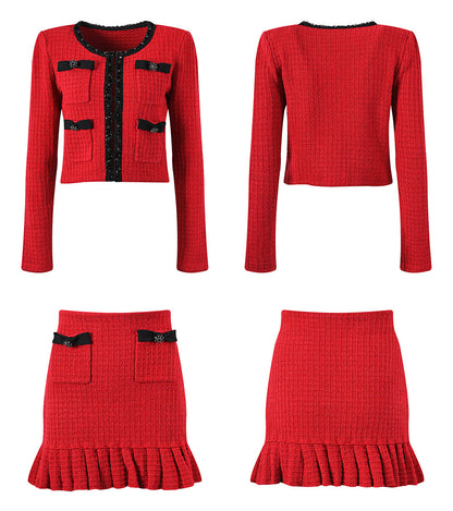 Striking red knitted wool jacket with black trim and decorative bows paired with a matching skirt featuring a flared hem