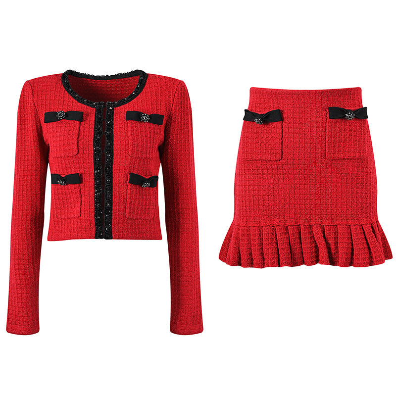 Striking red knitted wool jacket with black trim and decorative bows paired with a matching skirt featuring a flared hem