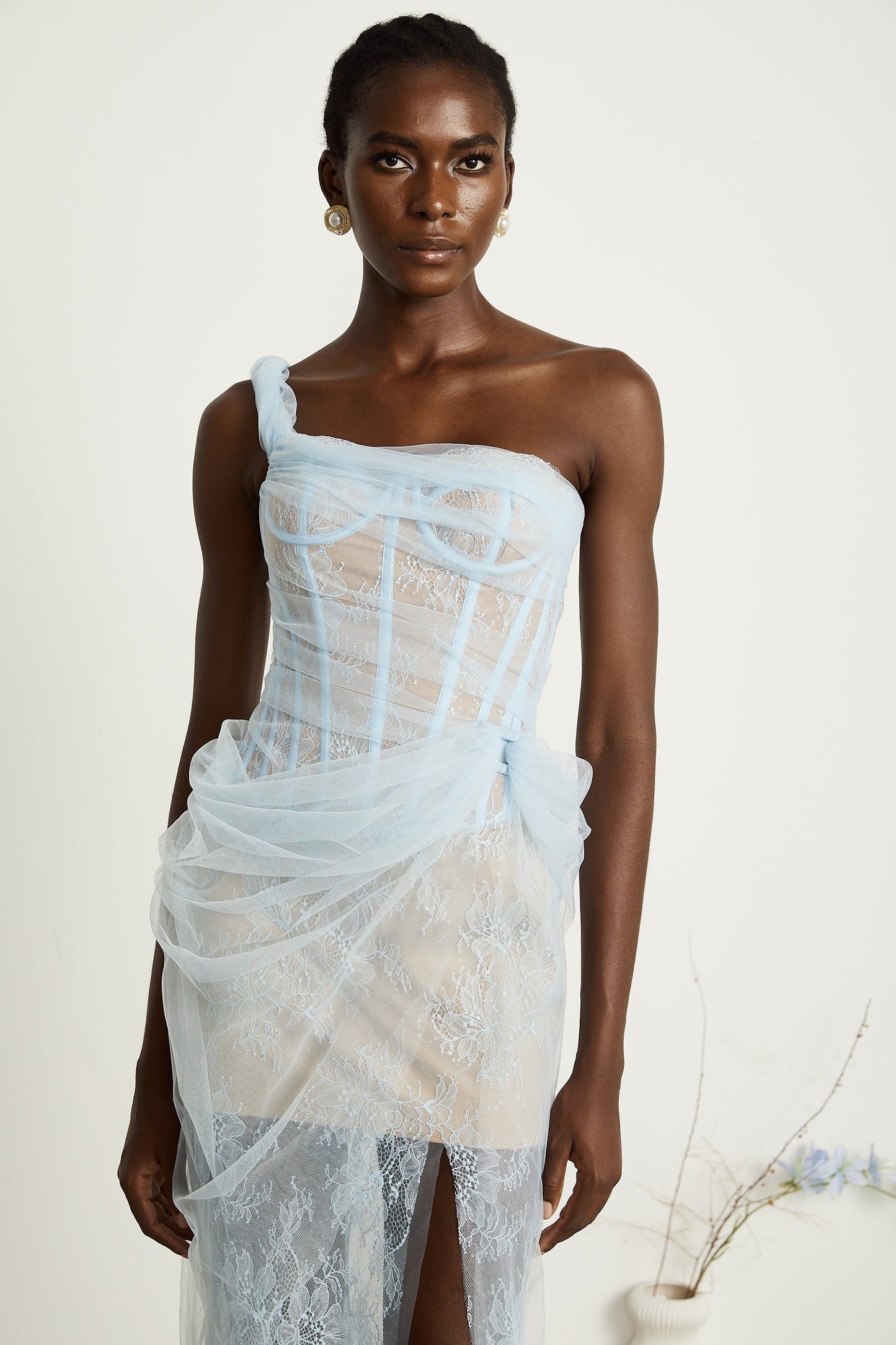 A blue pleated midi dress with mesh fabric featuring a flowing silhouette and delicate texture