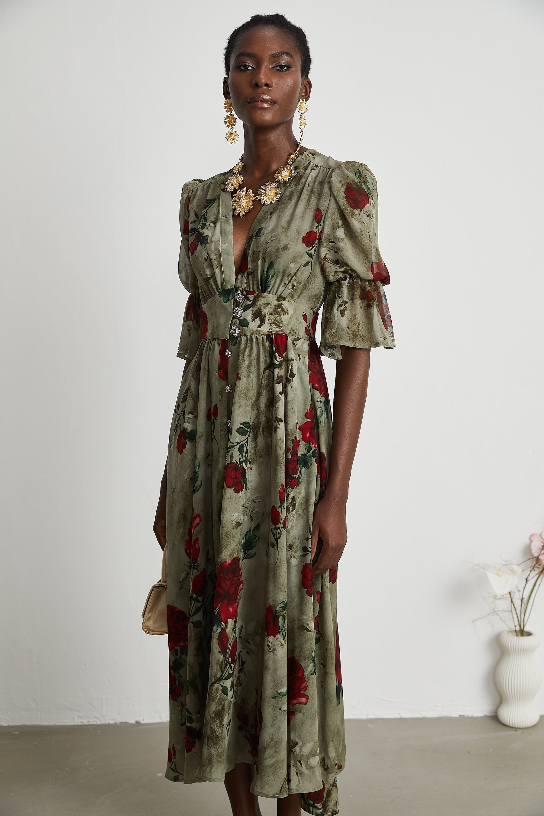 Woman wearing a floral print midi dress with V neckline and Melisande design