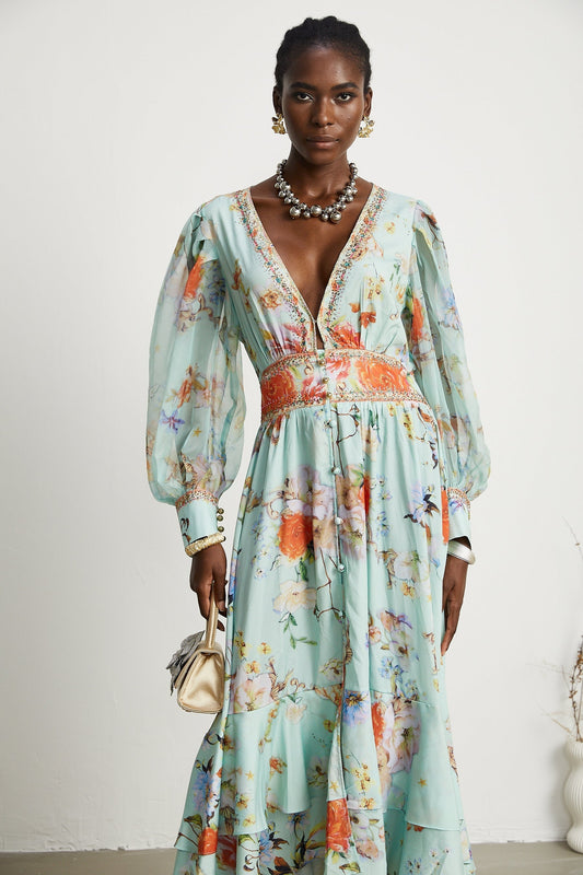 Woman wearing a long floral maxi dress with long sleeves and a Vneck