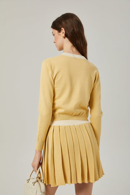 a matching wool cardigan and skirt set in a soft color