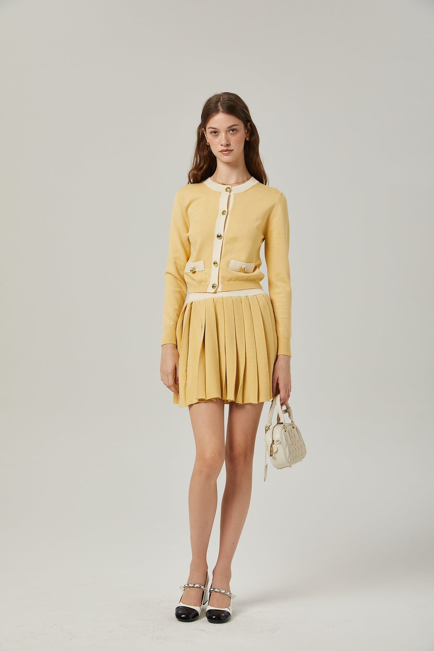 a matching wool cardigan and skirt set in a soft color