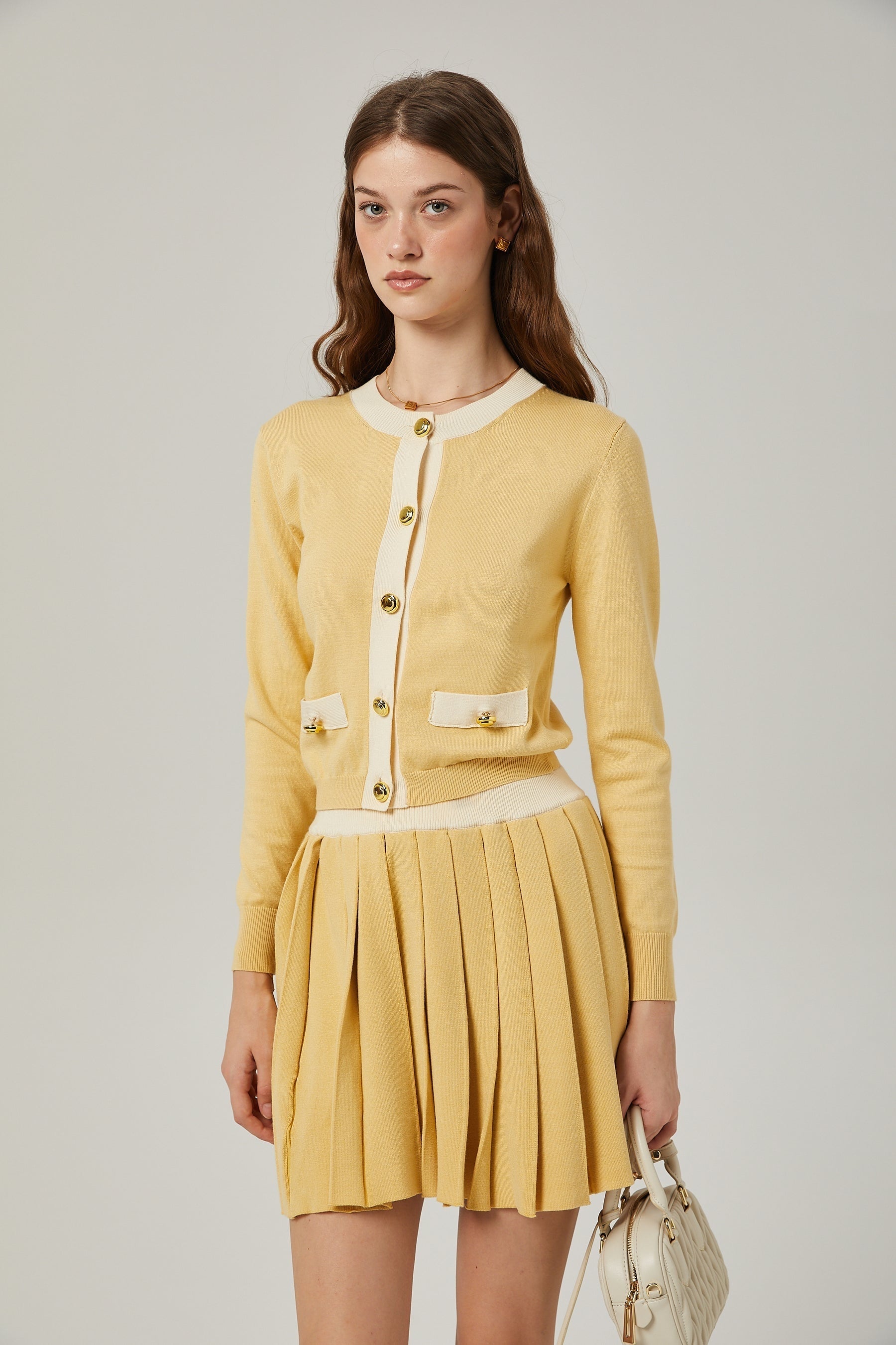 a matching wool cardigan and skirt set in a soft color