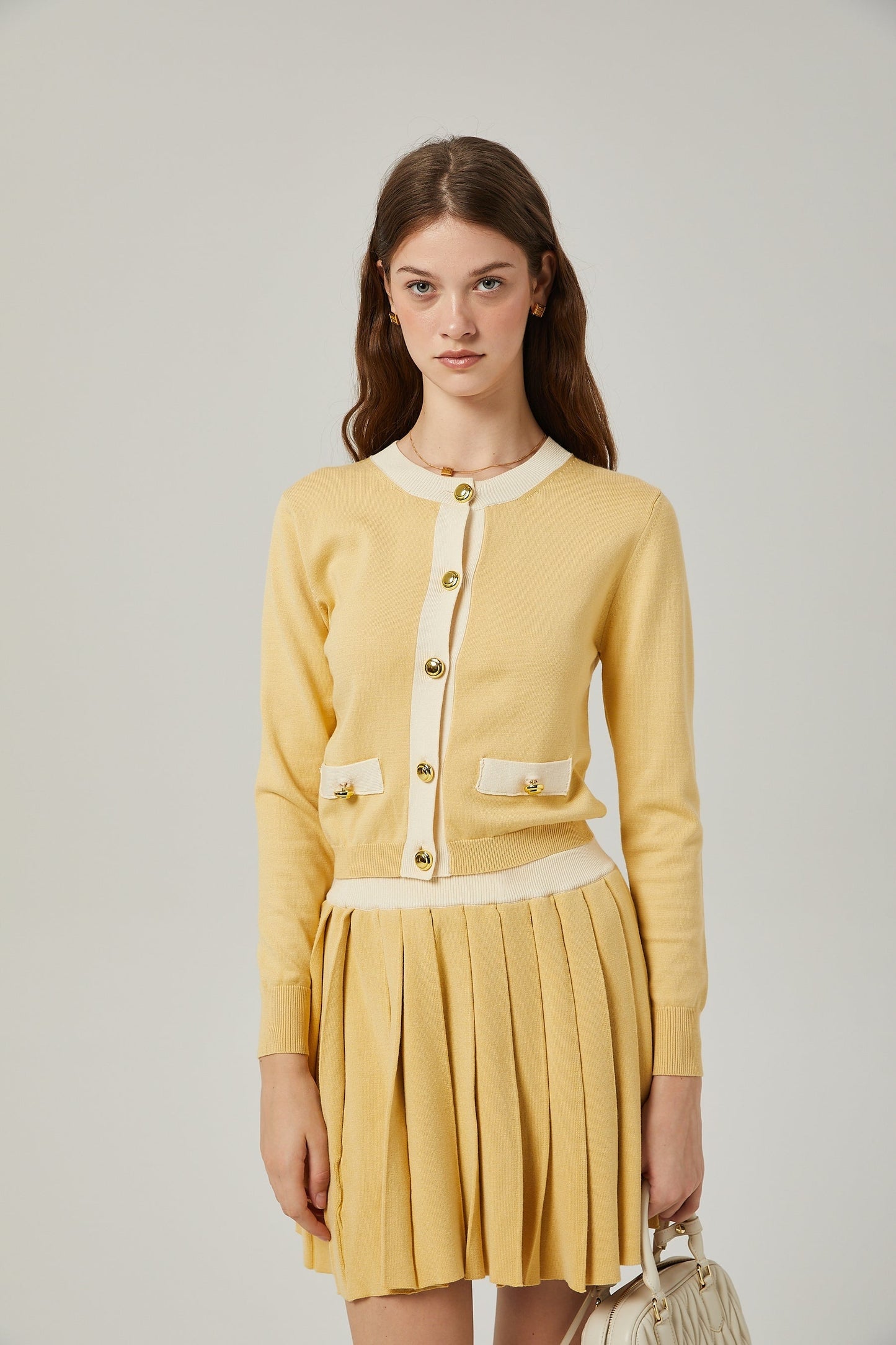 a matching wool cardigan and skirt set in a soft color