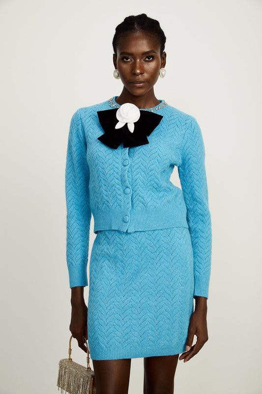 blue knitted cardigan and matching skirt set with embellished details