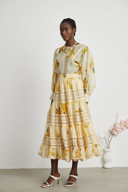 African American model wearing floral print yellow lace dress with ruffled skirt