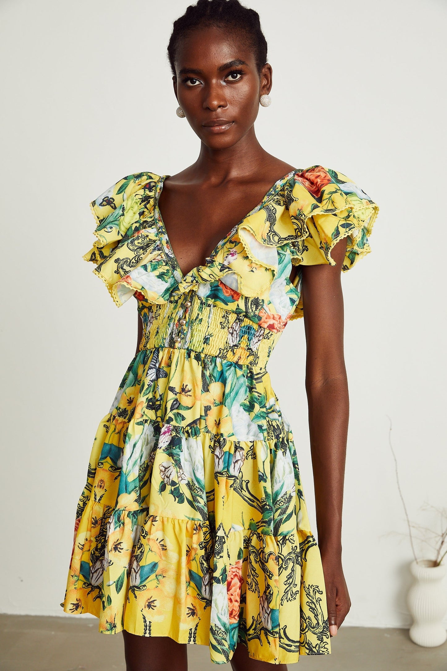 Yellow floral mini dress with ruffled details and allover print pattern