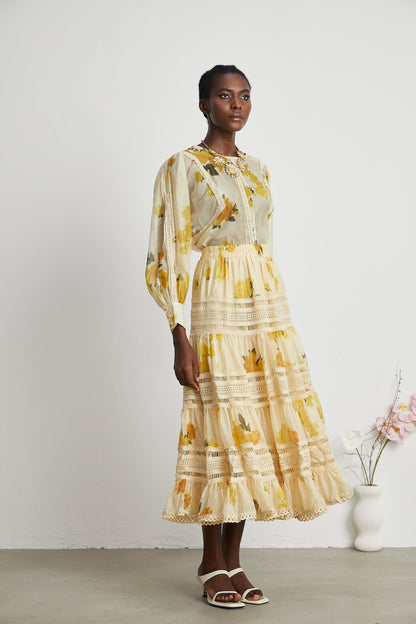 African woman wearing yellow floral print lace trim maxi dress