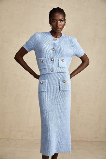 a matching blue knit blouse and skirt set